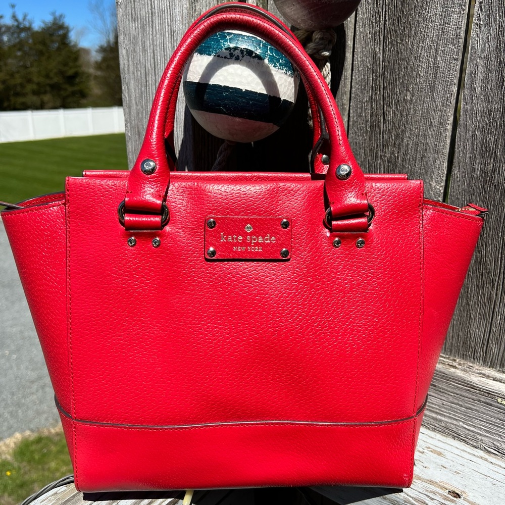Kate Spade red leather tote bag/purse with gold embellishments.